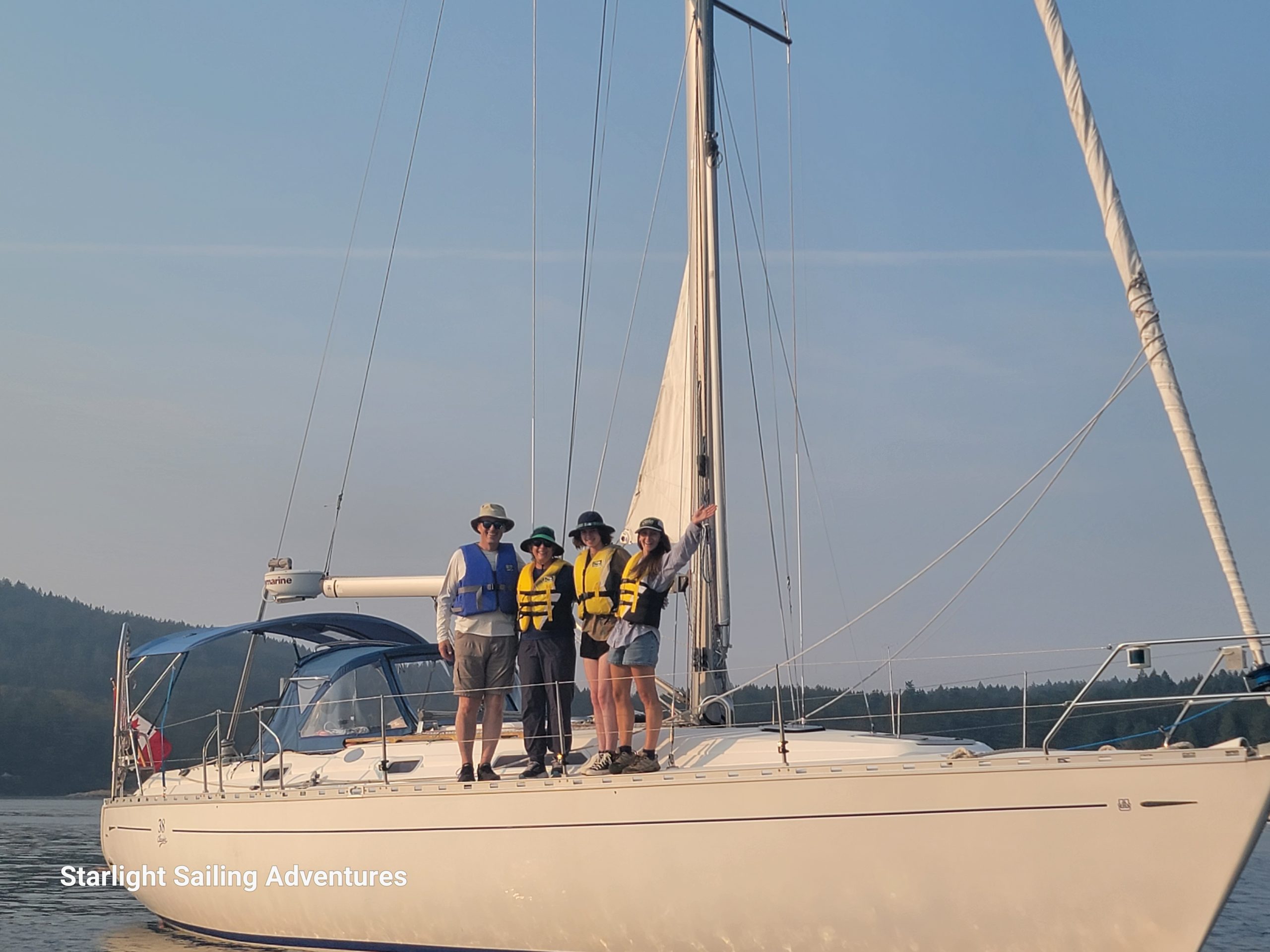 students standing on the sailboat anchored