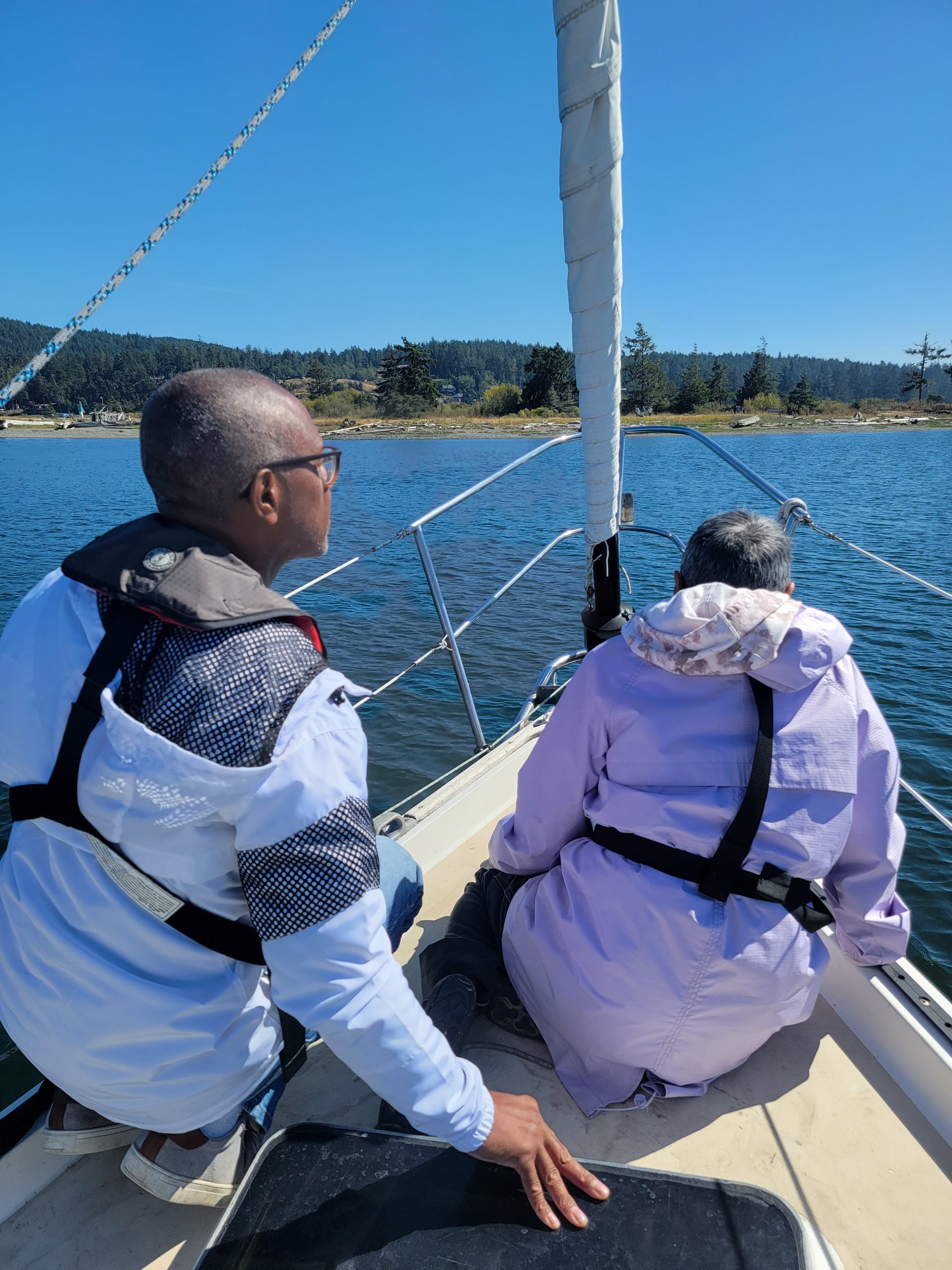 two students at the bow of the sailboat